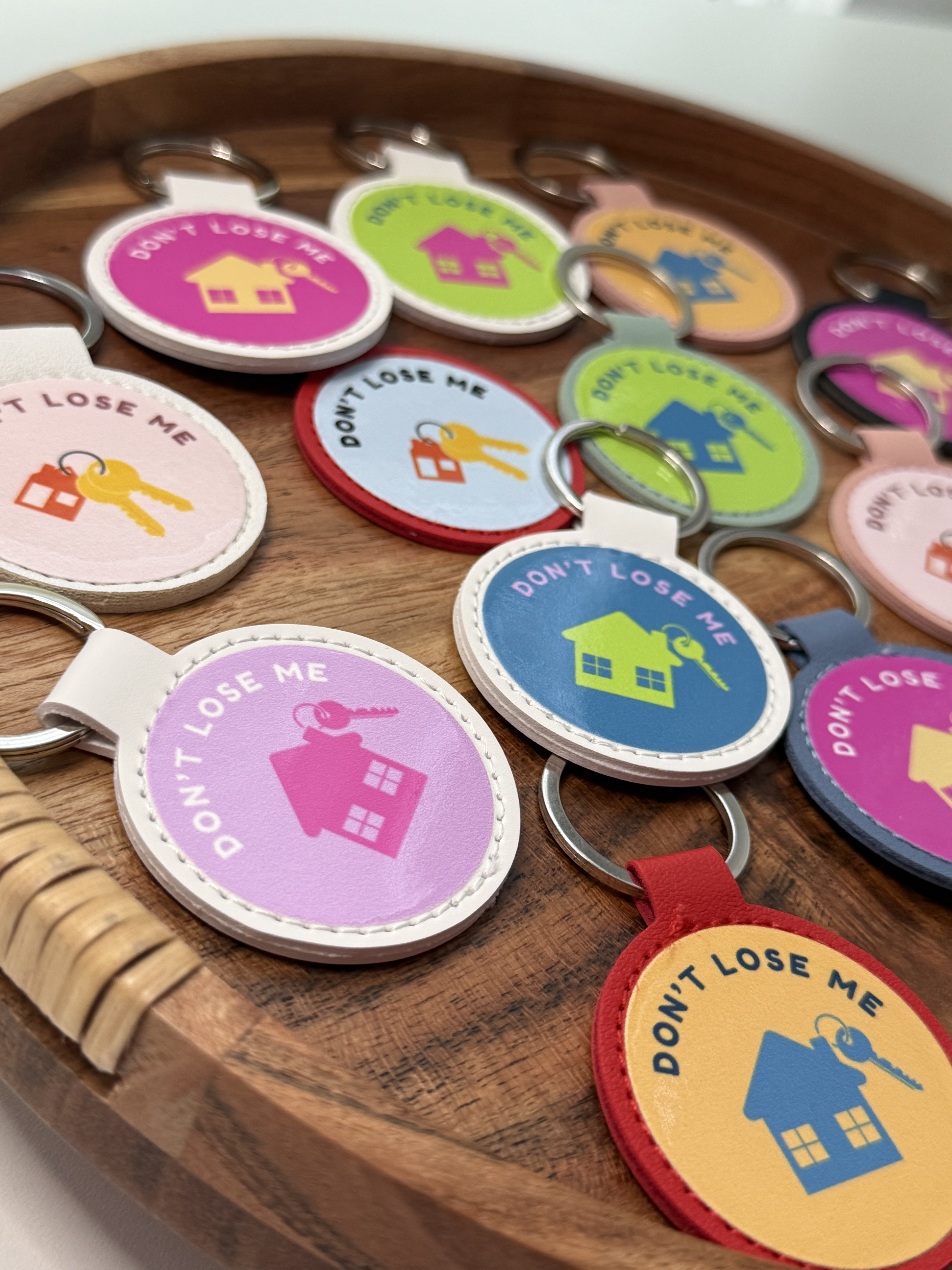 Round leather 'Don't Lose Me' keychains with house and key charms in an assortment of colors