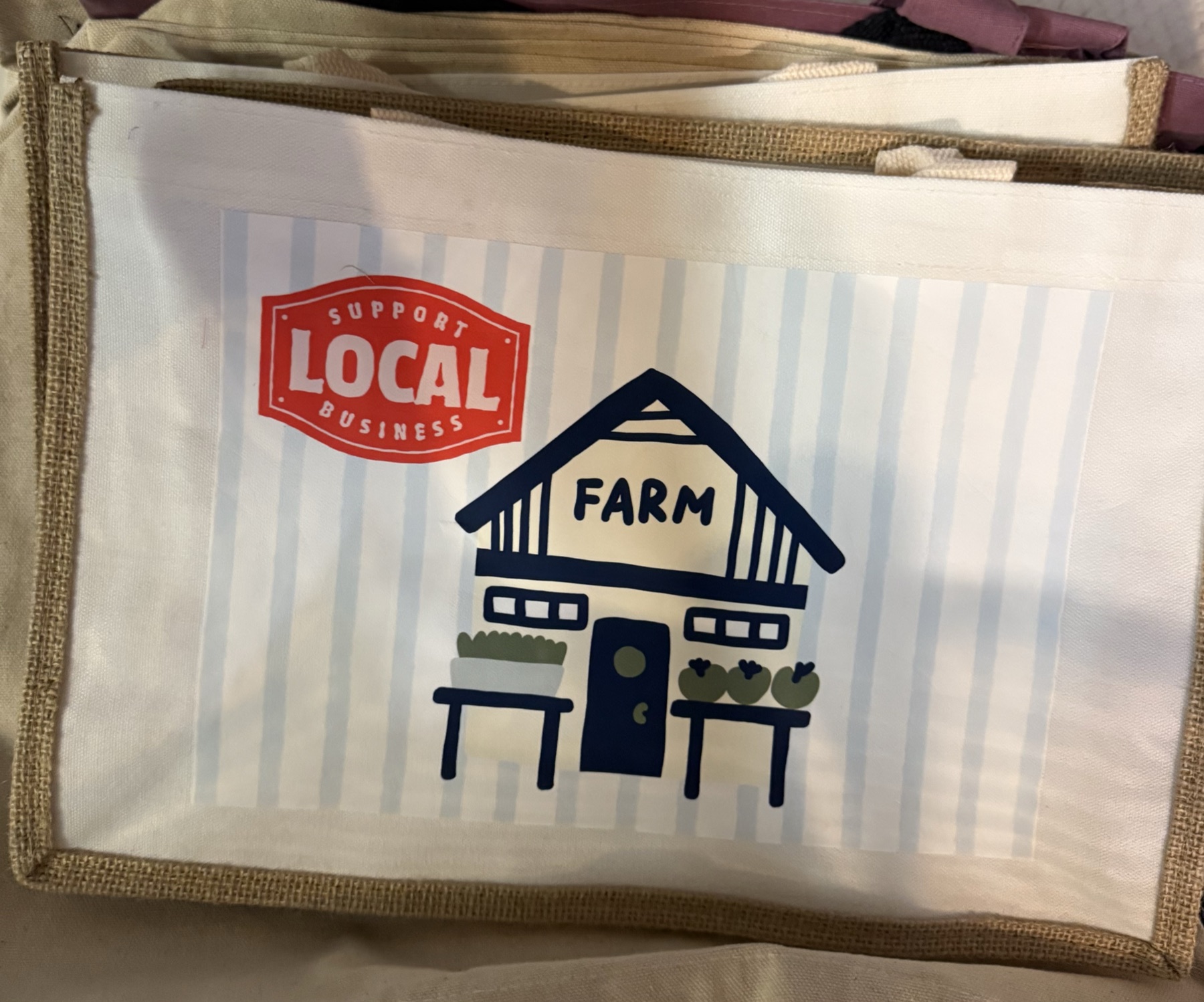 Canvas tote bag with a jute trim, printed with a Support Local Business farm design