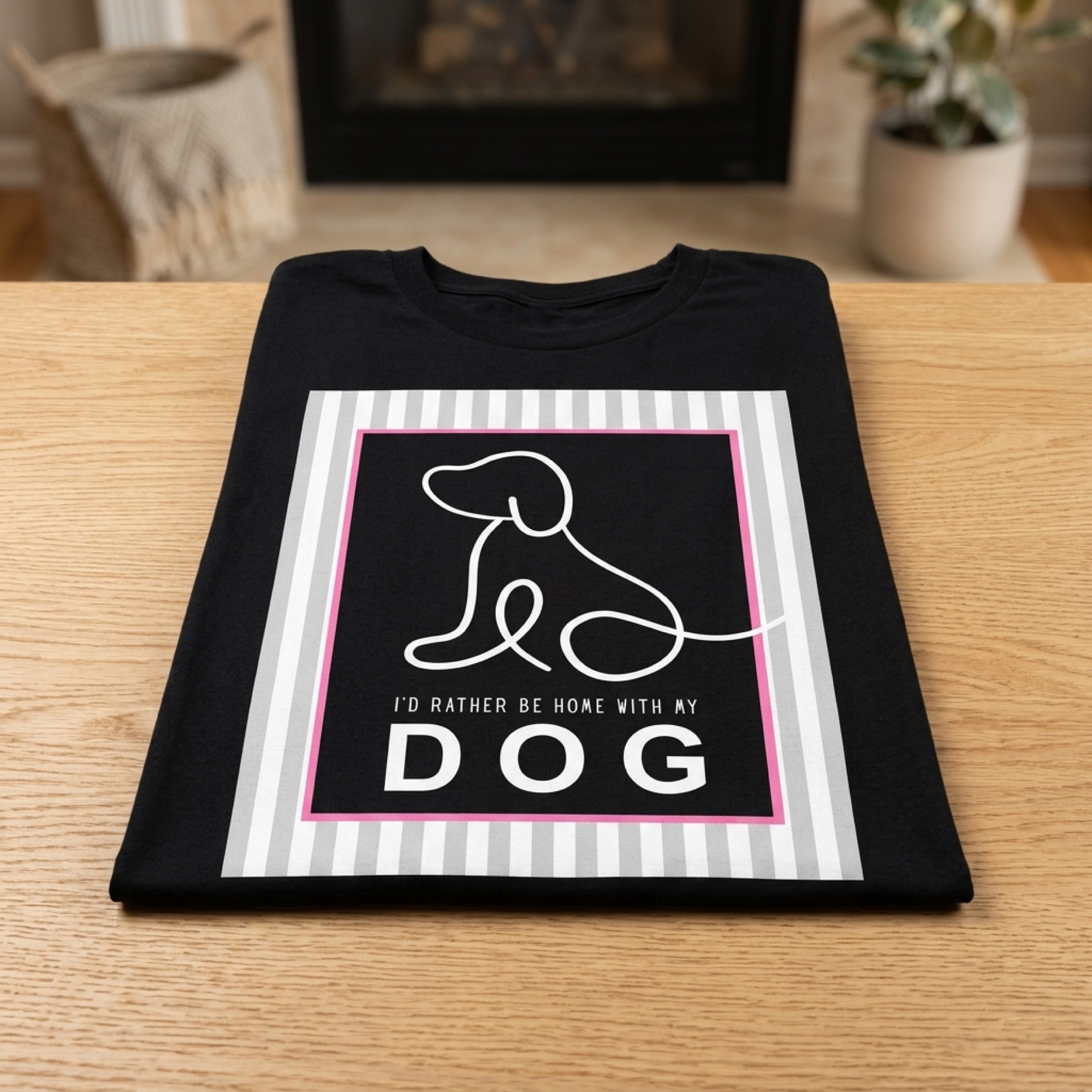 Folded black t-shirt with a white single-line dog illustration and the text I'd Rather Be Home With My Dog